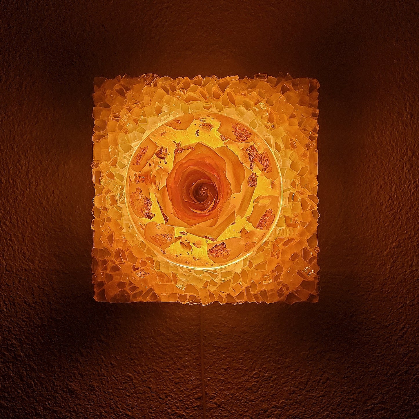 Decorative wall light with a warm glow on a dark background